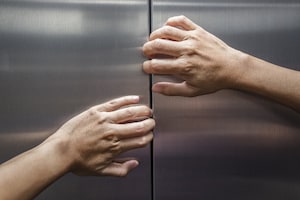 Person trying to open elevator door