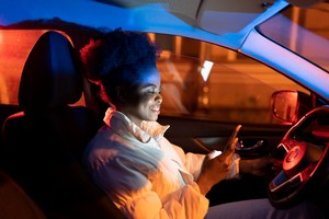 Woman watching phone while driving