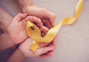 Hands with a Yellow Ribbon