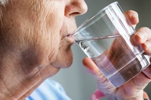 Elder person drinking water