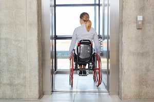 Lady on wheel chair using elevator