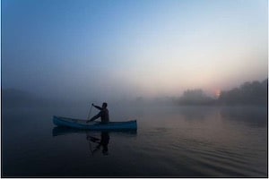 Man in Canoe with Mist