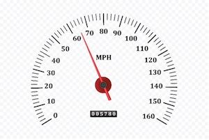 Analog speedometer labeled in MPH with needle pointing around 65 miles per hour.