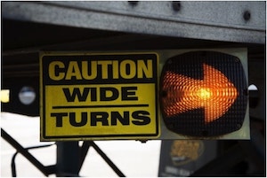 Caution Wide Turns sign